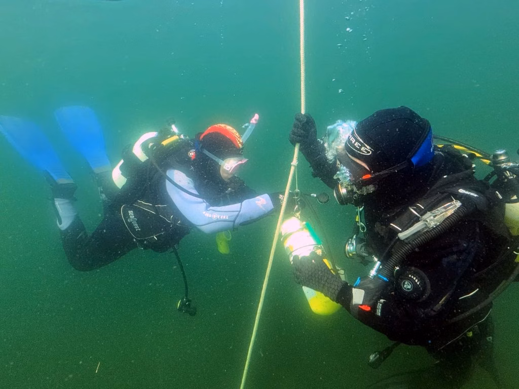 Various pictures of the divers learning underwater